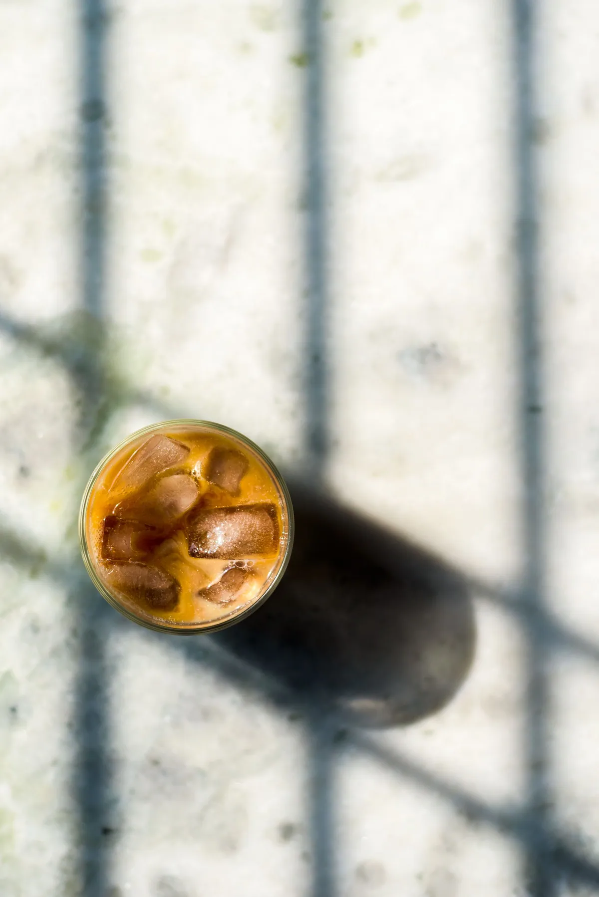 An iced latte from above in window light